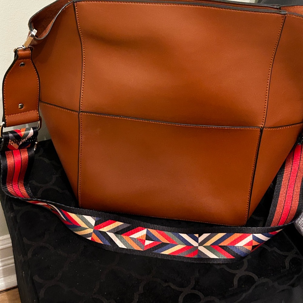 Hand bag with shoulder strap as well as cross body strap.